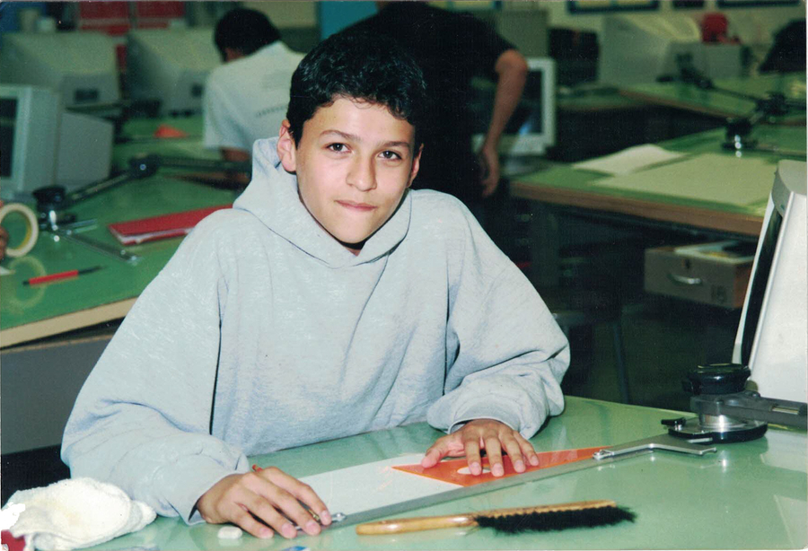 A photograph of Tony in a class room as a child